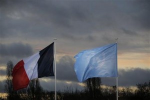 The flags of the U.N. and France fly as world leaders arrive for the COP21, United Nations Climate Change Conference, in Le Bourget, outside Paris, Monday, Nov. 30, 2015. (AP Photo/Christophe Ena, Pool)