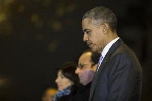 President Barack Obama, right, French President Francois Hollande, second from right, and Paris Mayor Anne Hidalgo pause for a moment of silence at the Bataclan, site of one of the Paris terrorists attacks, after Obama arrived in town for the COP21 climate change conference, on Monday, Nov. 30, 2015, in Paris. (AP Photo/Evan Vucci)