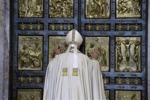 Pope Francis pushes open the Holy Door of St. Peter's Basilica, formally launching the Holy Year of Mercy, at the Vatican, Tuesday, Dec. 8, 2015. The 12-month jubilee emphasizes what has become the leitmotif of his papacy: to show the merciful and welcoming side of a Catholic Church more often known for its moralizing and judgment. (AP Photo/Gregorio Borgia)
