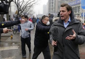In this Monday, Dec. 14, 2015, photo, a foreign journalist covering the trial of prominent rights lawyer Pu Zhiqiang is confronted by plainclothes policemen wearing yellow smiley-face stickers, near Beijings No. 2 Intermediate Court in Beijing. The tough guys wore smiley face stickers, but they werent there to spread good cheer. Scenes of pushing, shouting and shoving outside a Beijing courthouse this week were orchestrated by plainclothes security officers identified by a sticker familiar around the world the yellow decal identified since the 1970s with the slogan Have a Nice Day. (AP Photo/Andy Wong)