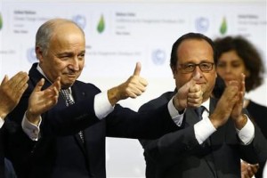 French President Francois Hollande, right, and French Foreign Minister and president of the COP21 Laurent Fabius react after the final conference at the COP21, the United Nations conference on climate change, in Le Bourget, north of Paris, Saturday, Dec.12, 2015. Governments have adopted a global agreement that for the first time asks all countries to reduce or rein in their greenhouse gas emissions. (AP Photo/Francois Mori)