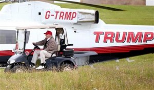 File - In this Friday, July 31, 2015 file photograph, U.S. presidential contender Donald Trump drives his golf buggy past his helicopter during the second day of the Women's British Open golf championship on his Turnberry golf course in Turnberry, Scotland. Britain's Supreme Court Wednesday Dec. 16, 2015, ruled unanimously against tycoon and U.S. presidential contender Donald Trump in his pitched battle to stop the construction of an offshore wind farm near his upscale Scottish golf resort. (AP Photo/Scott Heppell-File)