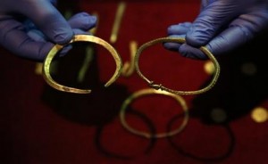 A close up of some of the jewellery and ingots of a significant Viking Hoard found near Watlington, in Oxfordshire, England as they are displayed at the British Museum in London, Thursday, Dec. 10, 2015. The hoard  contains 186 coins, seven items of jewellery and 15 ingots of precious metal. The items include rare coins from era of King Alfred the Great (871-899) and King Ceolwulf II (874-79) when the kingdoms of Mercia and Wessex  fought the invading 'Great Heathen Army' also known as the great Danish army, in the late 800's.(AP Photo/Alastair Grant)