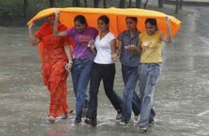 Girls cover themselves from rain in Chandigarh